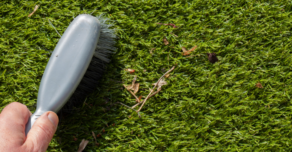 Brushing debris off artificial lawn